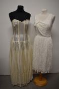 A 1950s white lace evening dress and a heavily boned strapless dress/ under dress in ivory taffeta.