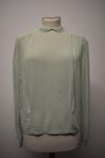 A mint green 1930s semi sheer blouse, having ladder work to collar and cuffs, medium size.