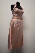 A 1950s pink satin Susan Small model halterneck dress, having extensive braiding and diamante