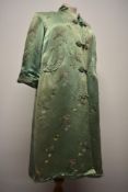A mint green Chinese dressing gown, having frog fastening to front, two pockets and three quarter