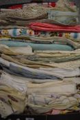 A box of vintage and antique table linen, including embroidered, coloured and lace edged items.