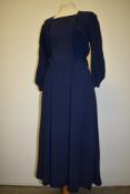 A late 30s/ early 40s navy blue day dress having rushed detail to tapered bodice, full skirt, side