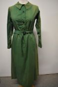 A green cotton 1930s/40s day dress with belt, long sleeves and buttons to front. some fade.