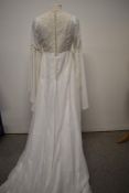 A vintage 1960s wedding dress, having angel sleeves and floral crochet appliqué.