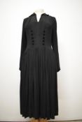 An early 1940s black crepe day dress, having very full pleated skirt, gathered sides to bust,