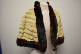 A 1930s ermine cape having contrasting mink trim.