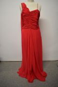 A late 1940s/ early 50s pink crepe georgette dress in cerise pink, with faux shawl detail to