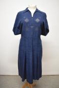 A 1940s navy blue day dress having unusual textured design and ladder work to bodice, brass side