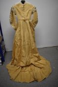 A Victorian cream silk dress having tassel trim to bodice, tape work to neck and sleeves and