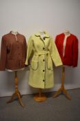 A vintage yellow wool coat and two jackets, including one of red mohair.