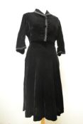 A 1950s/60s black velvet dress and matching bolero, having bead and braided trim to cuffs, collar