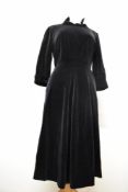 A late 1940s black velvet A line day dress having statement collar, turn up cuffs to 3/4 sleeves and