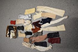 A box full of vintage and antique gloves, various colours and eras.