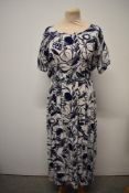 An early 1950s blue and white linen day dress having abstract floral pattern, belt to waist, short