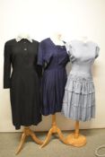 Three 1950s dresses, including pale blue dress with drop waist, braid and bead detailing, and navy