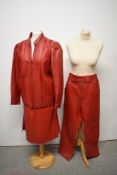 A 1970s/80s red leather three piece suit, comprising jacket, trousers and skirt.