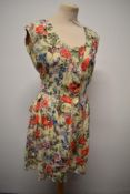 A 1980s floral playsuit, having buttons to front and tie belt to waist, 'Tigi-Wear by Rinku'.