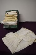 A box full of babies and children's clothing, dresses, gowns and embroidered shawls and more amongst