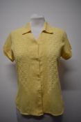A 1940s lemon yellow blouse in a linen-like fabric, having extensive embroidery to front and turn-