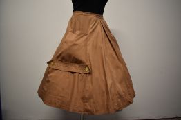 A 1950s taupe cotton skirt, having large pockets to sides, with button and stitched detailing to