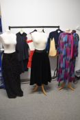 A selection of vintage and retro clothing, mixed sizes, colours and styles.