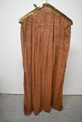 A vintage brown cotton clothes bag with brass fittings.