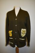 A 1960s American college cardigan in brown and cream, with the name 'Darlene' embroidered front.