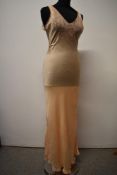 A 1930s Art Deco pale peach silk nightdress, having deep lace insert to bodice, cut on the bias with