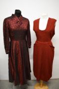 A 1940s red evening dress in patterned taffeta and a red wool 1950s pinafore.