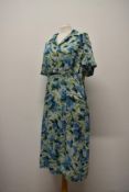 A vibrant 1950s day dress in a floppy rayon type fabric having bright absract floral print, larger