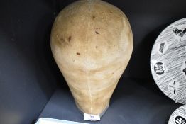 An early 20th century canvas covered milliners form. Size 56.