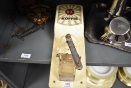 A Mid Century French wall mounted coffee grinder.