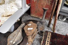 Two vintage block and tackle pulley with a fuel can and a cobblers last.