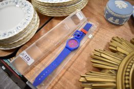 A Whiskas advertising watch having blue rubber strap.