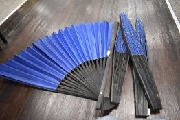 Four large decorative oriental fans having ebonised frames with plain fan cover.