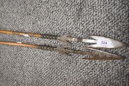 Two early 20th century ethnic tribal fishing spears with iron heads.