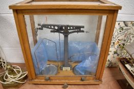 A vintage set of Philip Harris Apothecary or Chemist scales in fitted oak and glazed case.