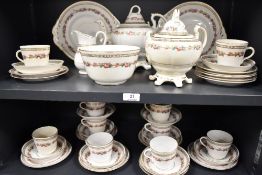 A Victorian porcelain part tea service having white ground with gilt decoration and enamel