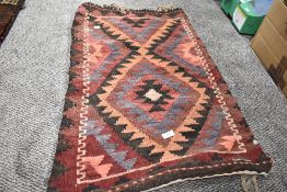A 20th century Persian Afghan Balouch saddle bag in woven wool in a blue purple and red ground
