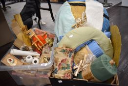 A collection of lace working items including bobbins cushions and patterns.