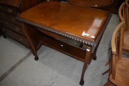 An early 20th Century mahogany side table having gadrooned edge shaped leg with ball and claw feet