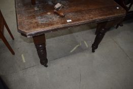 A Victorian oak wind out dining table, top rough with no additional leaves