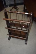 A vintage oak and stained frame three tier magazine rack