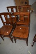 A set of four traditional chapel style dining chairs