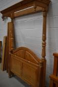 A modern pine half tester bed frame, having wide slat base