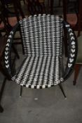 A vintage basket weave tub chair