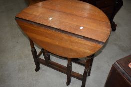 An early 20th century oak Sutherland table, of traditional design with turned gated supports and
