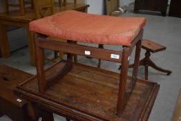 A vintage teak stool with orange seat covering, E Gomme (G plan)