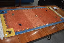 A traditional wool rug having vibrant avian design approx 140 x 70cm