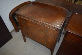 A 1940s utility type oak ply chest of three drawers